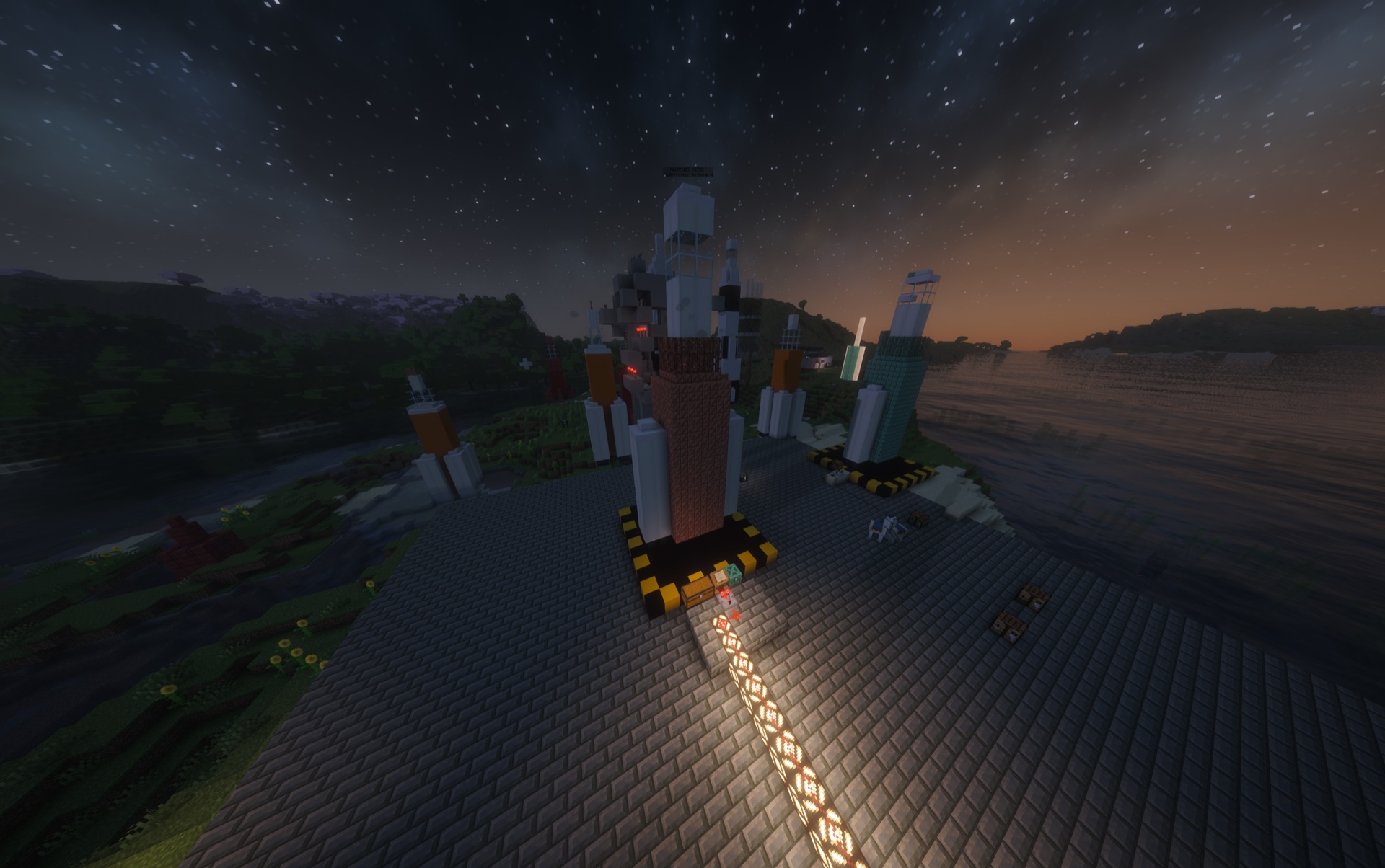 Artemis standing on a completed launch pad beside Mission Control